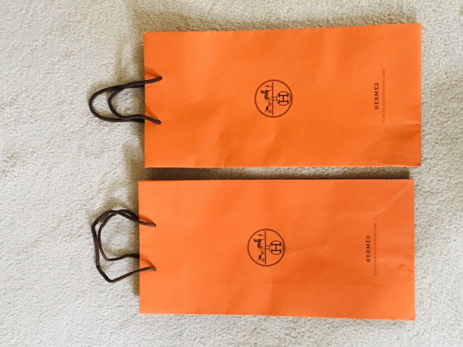 authentic hermes orange shopping bag with ribbon. approx 12x12x4.